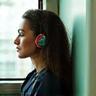 Person listening to headphones on a bus or train