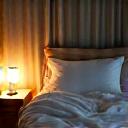 A peaceful bedroom scene with soft lighting, symbolizing evening calm